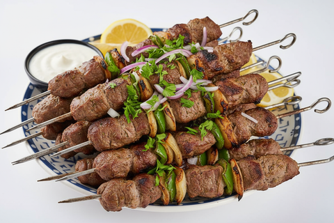 خلفية بيضا صحن اسياخ معدن شقف غنم مشوي لبناني مزين بقدونس مفروم مع بصل موف